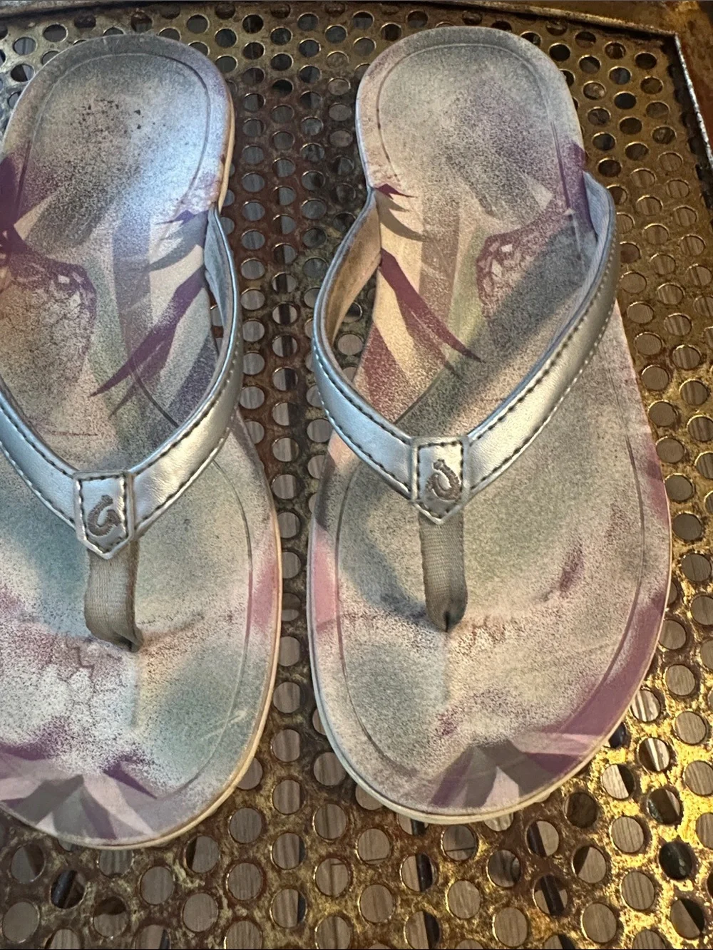 OluKai Metallic Silver Flip Flops with Purple Floral Accent